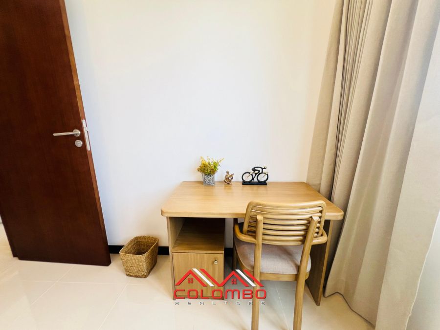 Bedroom with table of Tri-Zen Tower 1 Apartment for Rent or Lease in Colombo 2 by Colombo Realtors
